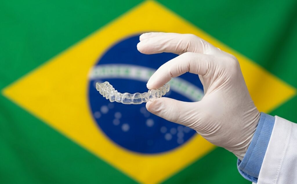 doctor showing a clear aligner to indicate that he is talking about invisalign treatment time in brazil